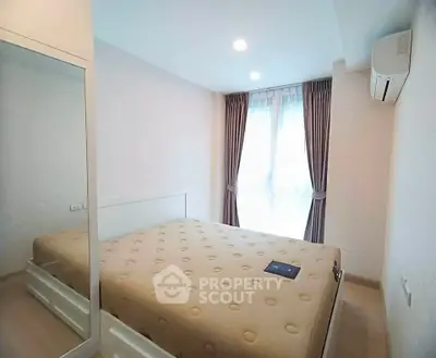 Bright and cozy bedroom with modern furnishings and ample natural light.