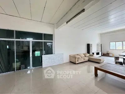 Spacious living room with modern furniture and large windows for natural light.