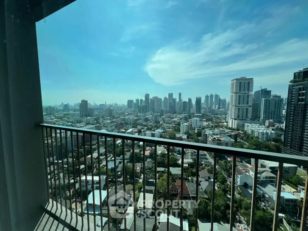 Stunning cityscape view from high-rise balcony with expansive skyline and modern architecture.