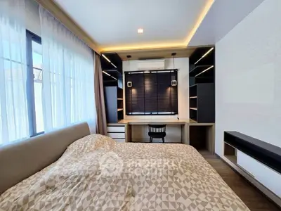 Modern bedroom with stylish built-in desk and shelving, featuring large windows and elegant lighting.