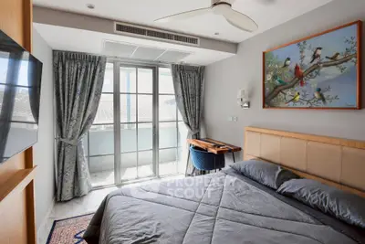 Cozy bedroom with modern decor and balcony access in a stylish apartment.