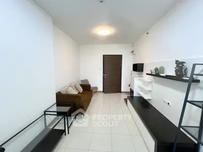 Modern living room with sleek furniture and minimalist design, featuring a cozy brown sofa and stylish shelving.