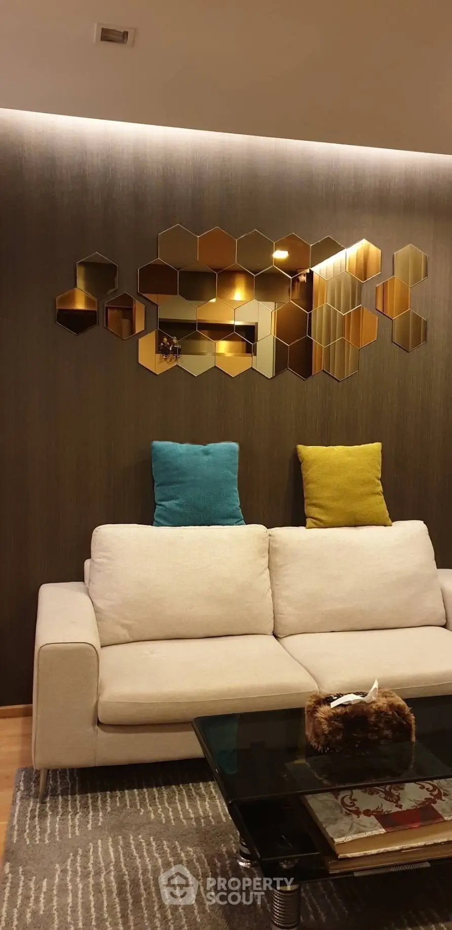 Modern living room with stylish hexagonal wall decor and cozy sofa