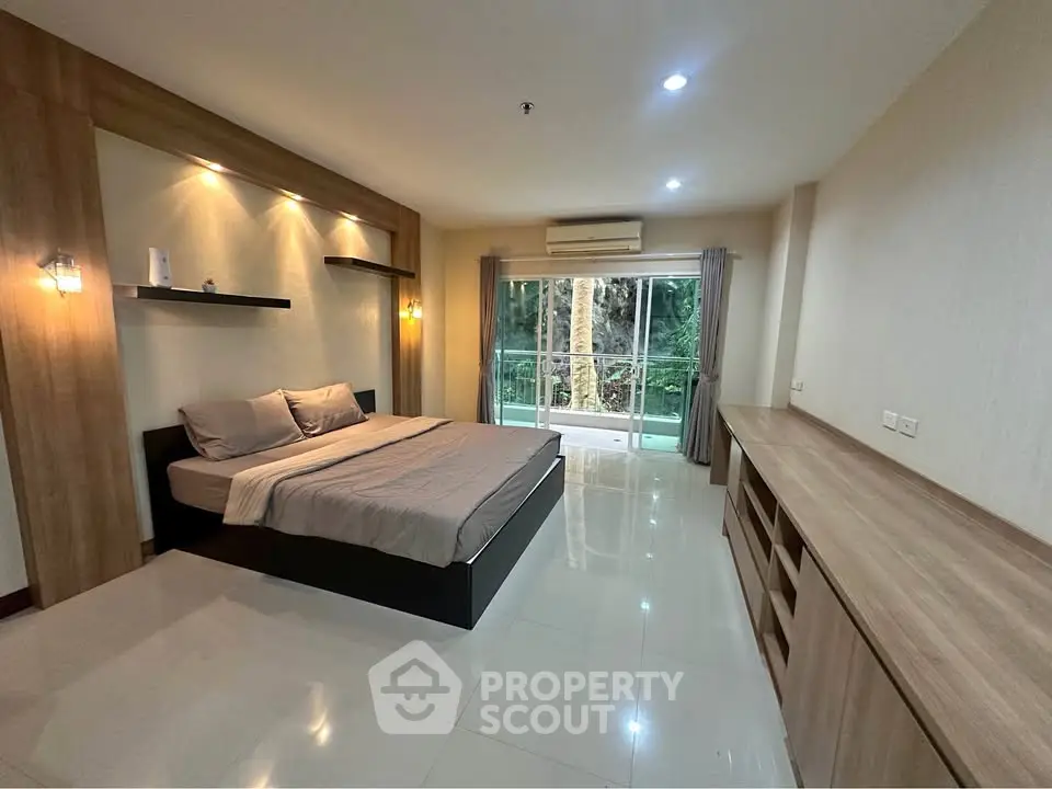 Spacious bedroom with modern design and balcony view