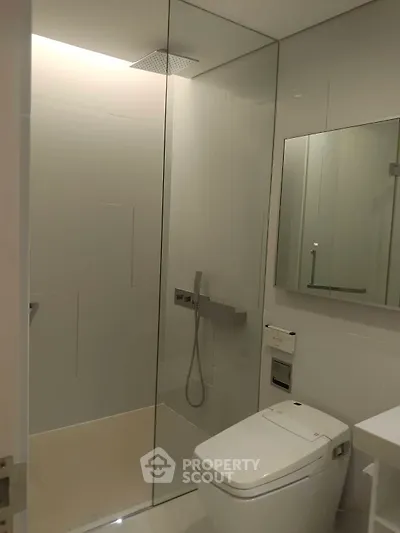 Modern bathroom with sleek shower and contemporary fixtures.
