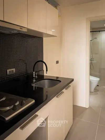 Modern kitchen with sleek black countertop and built-in electric stove