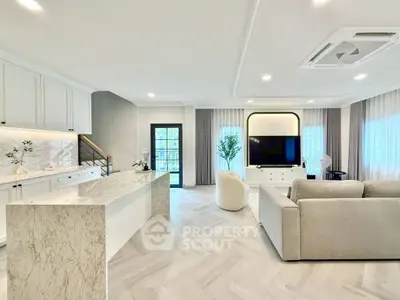 Luxurious open-plan living room with modern kitchen and elegant decor
