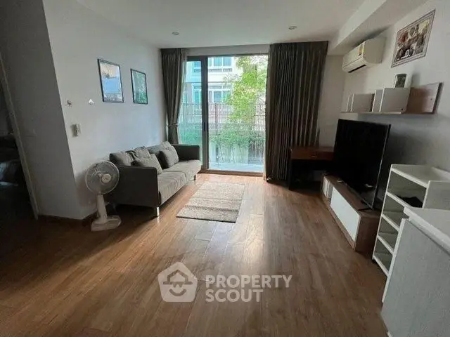 Spacious living room with modern decor and large window view