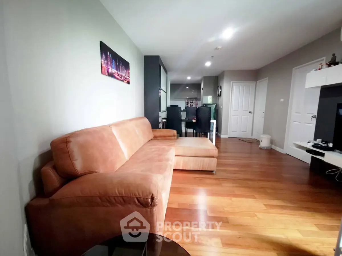 Spacious living room with modern decor and wooden flooring