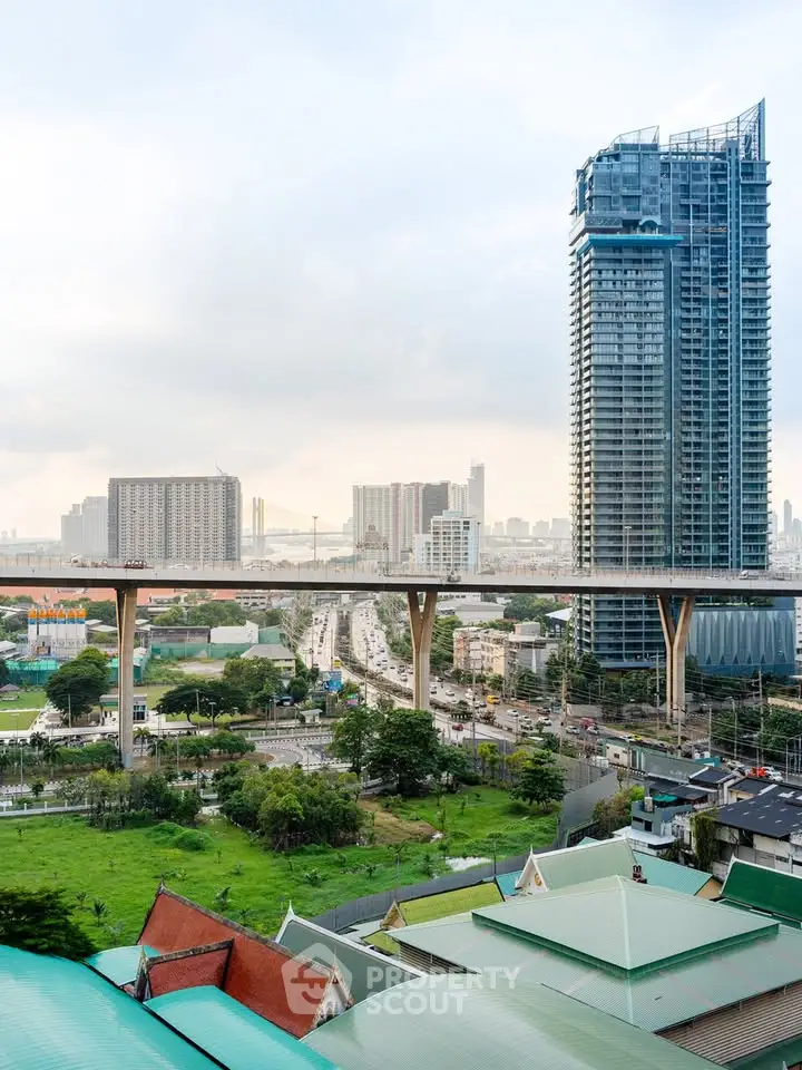 Stunning cityscape view with modern high-rise building and elevated highway, showcasing urban living.