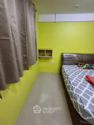 Cozy bedroom with vibrant yellow walls and modern furnishings