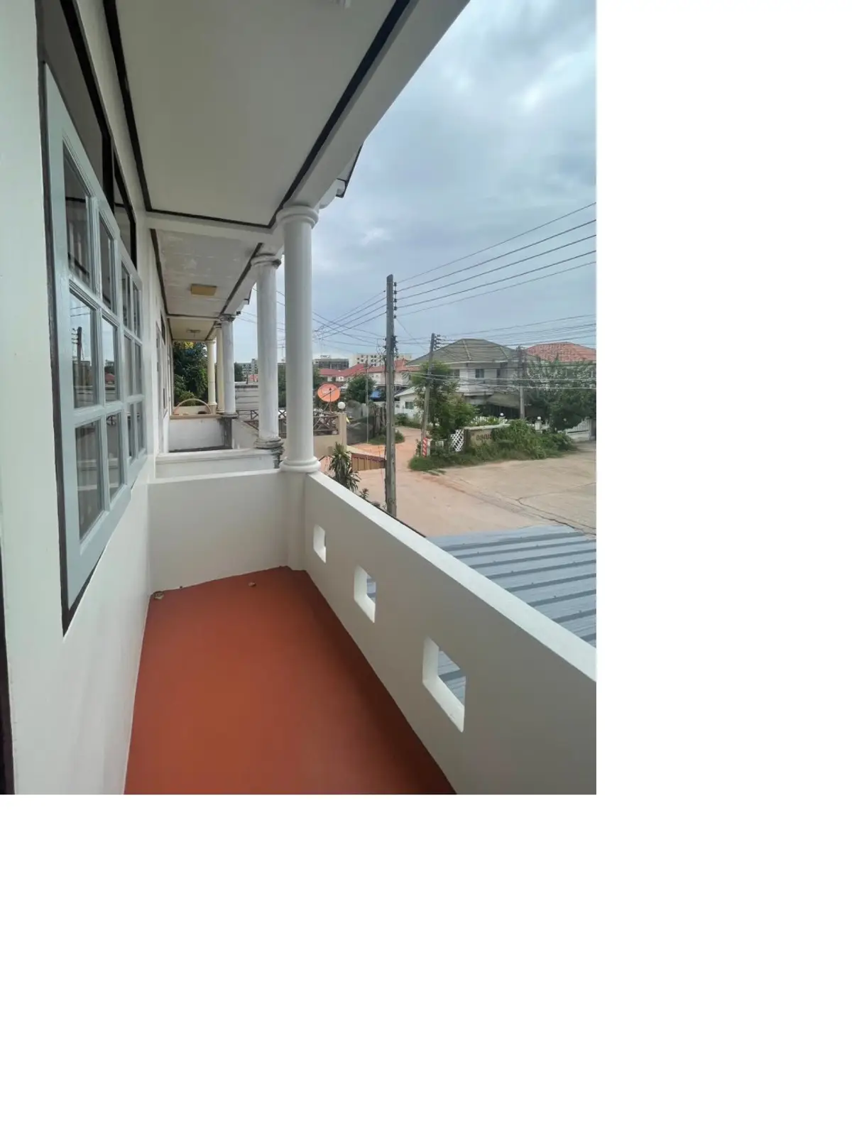 Spacious balcony with scenic neighborhood view, perfect for relaxation and outdoor enjoyment.