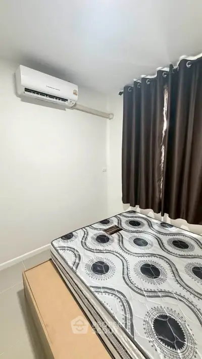 Cozy bedroom with air conditioning and stylish curtains, perfect for restful nights.