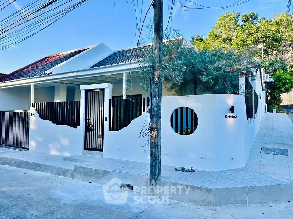 Charming modern house with unique architectural design and lush greenery, perfect for serene living.