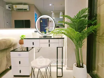 Modern living room with stylish vanity, lush plant, and elegant decor