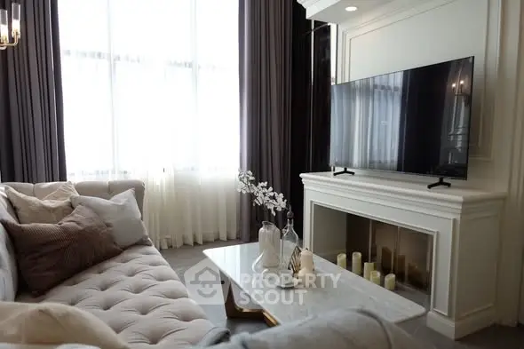 Elegant living room with plush sofa and modern TV setup