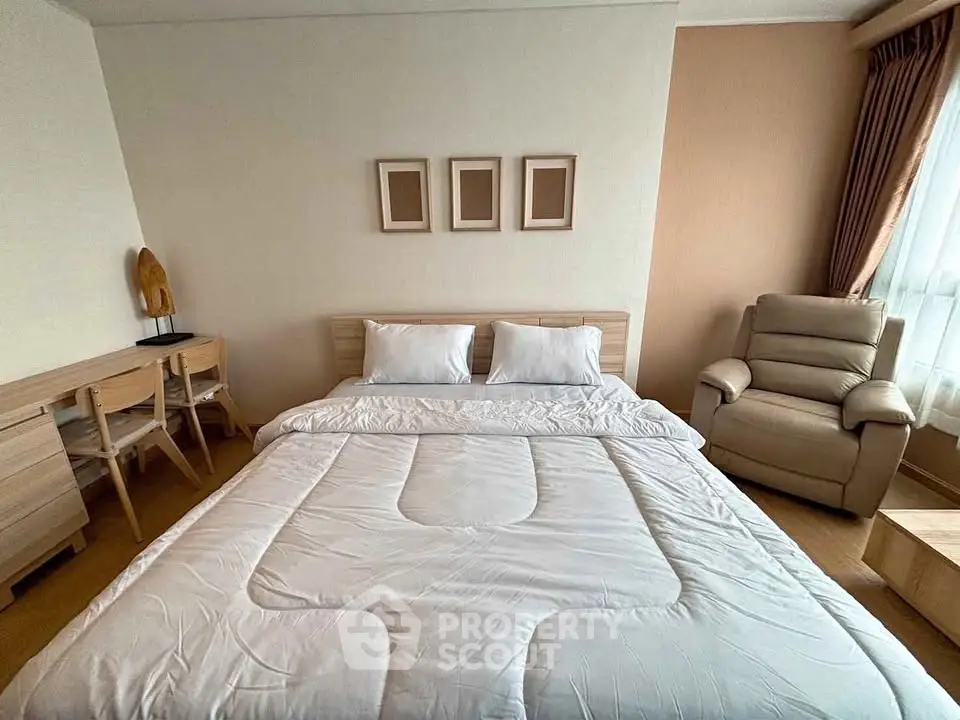 Cozy bedroom with modern furniture and natural light, perfect for relaxation and comfort.