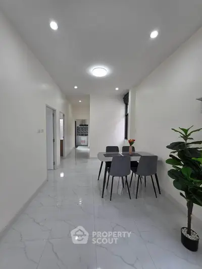 Modern dining area with sleek marble flooring and stylish furniture