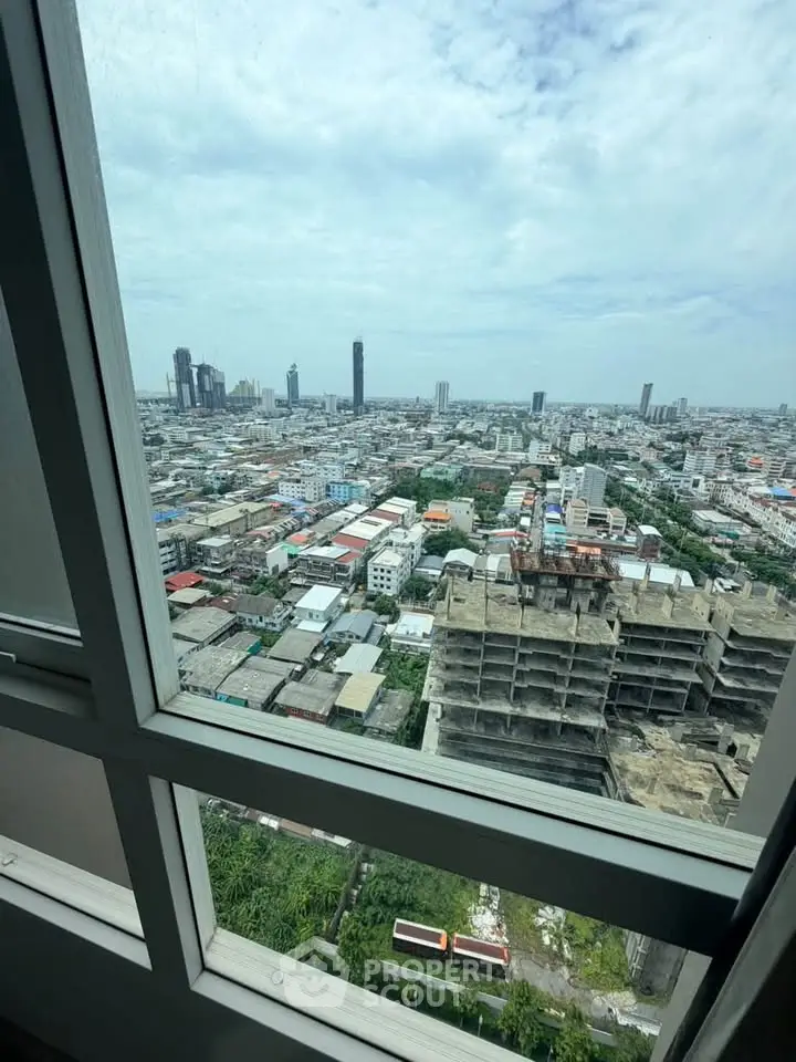 Stunning cityscape view from high-rise window showcasing urban skyline and architectural diversity.