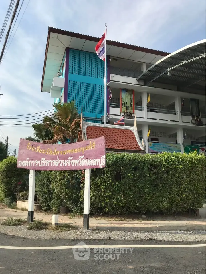 Modern building exterior with colorful facade and lush greenery
