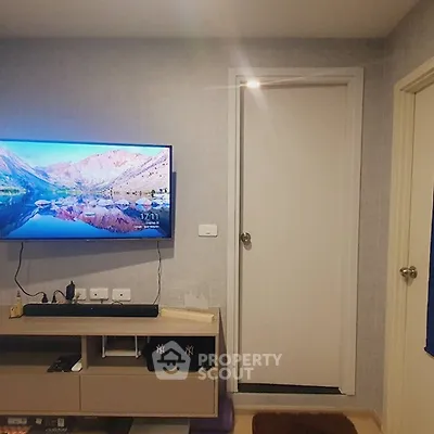 Modern living room with wall-mounted TV and sleek storage unit
