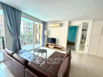 Spacious living room with modern decor and balcony view