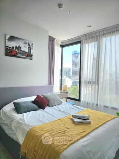 Modern bedroom with city view, large windows, and stylish decor