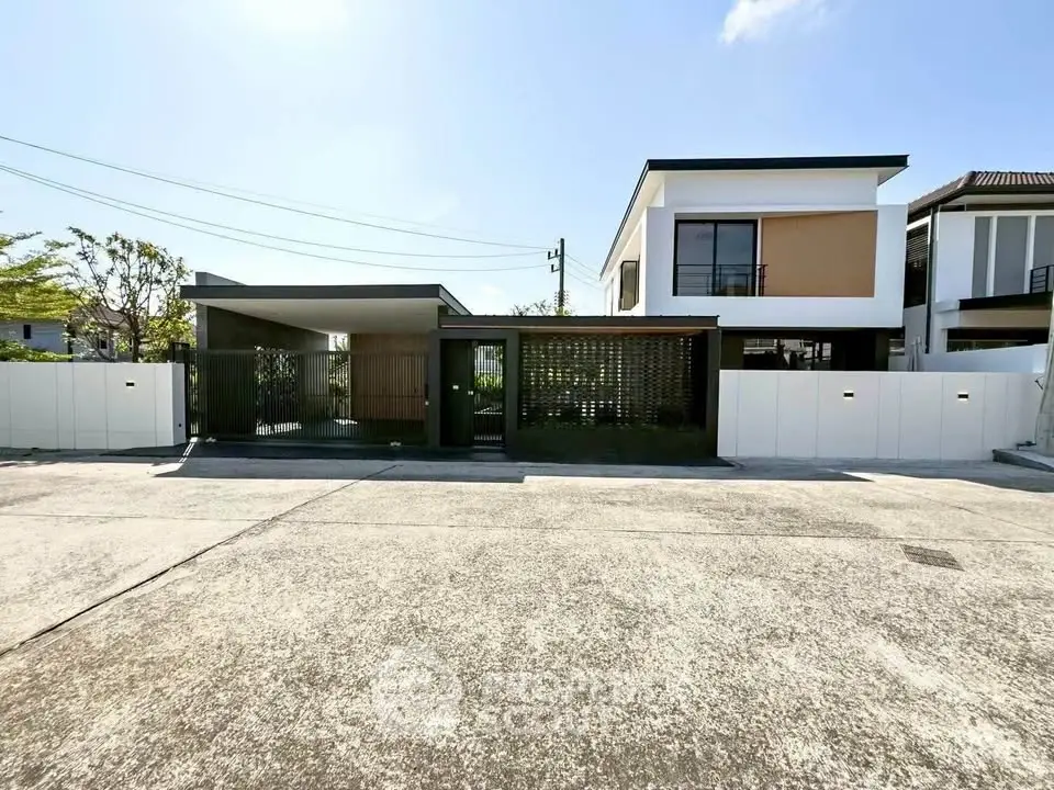 Modern minimalist house exterior with sleek design and spacious driveway.
