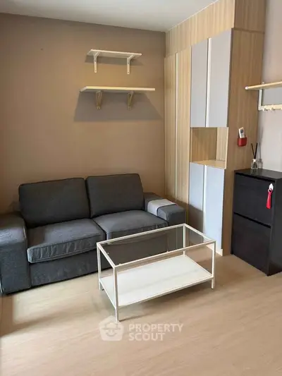 Modern living room with sleek sofa and minimalist decor in stylish apartment.