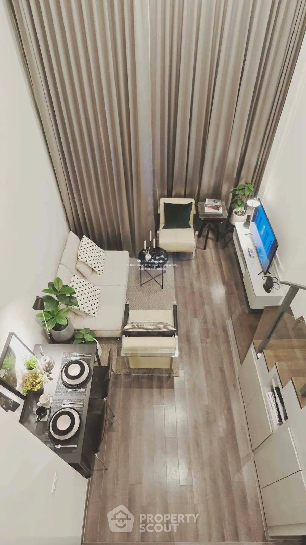 Modern loft-style living room with high ceilings and elegant decor