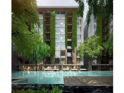 Luxurious modern apartment building with lush greenery and inviting pool area.