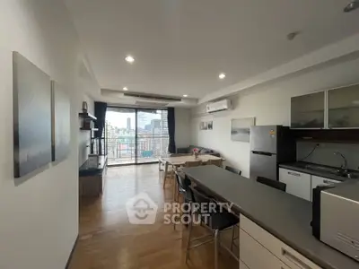 Spacious modern living room with open kitchen and city view balcony