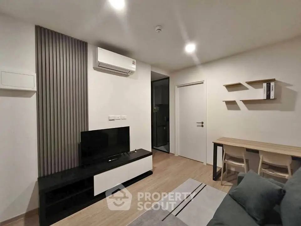 Modern living room with sleek furniture and air conditioning in a stylish apartment.