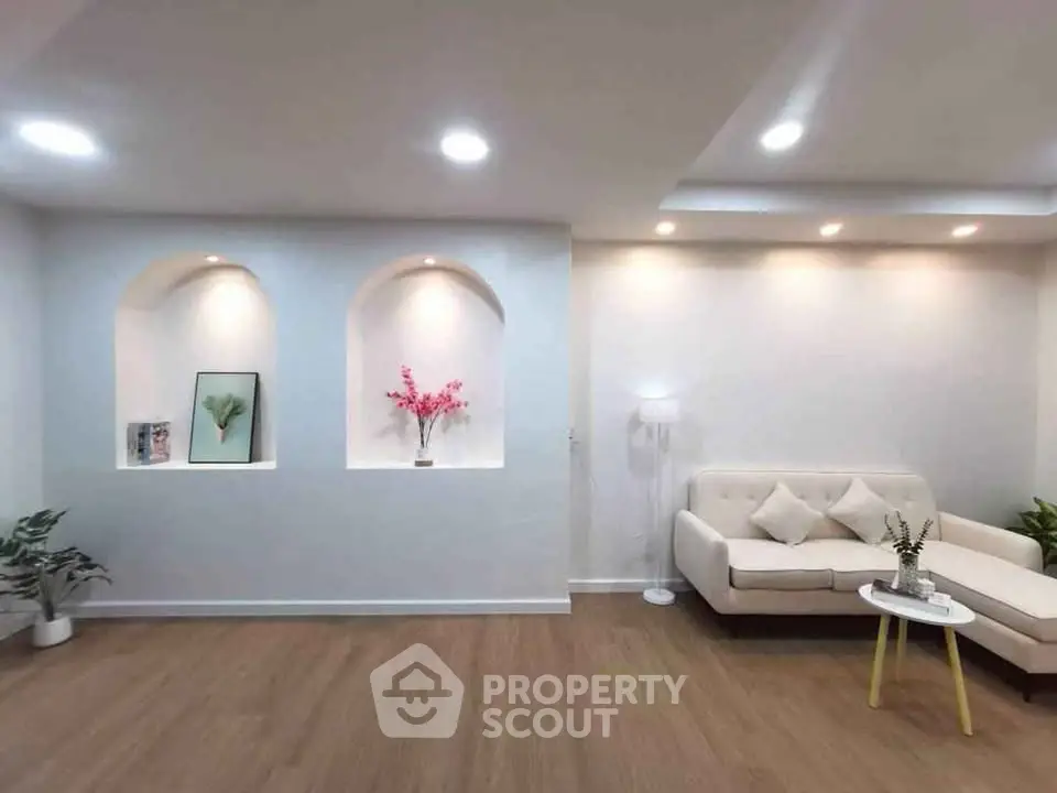 Modern living room with elegant decor and recessed lighting