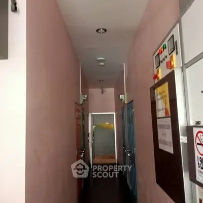 Narrow corridor with multiple doors in a residential building