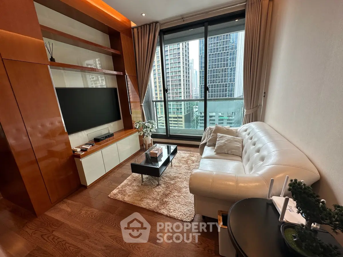 Luxurious living room with modern decor and stunning city view from large windows.
