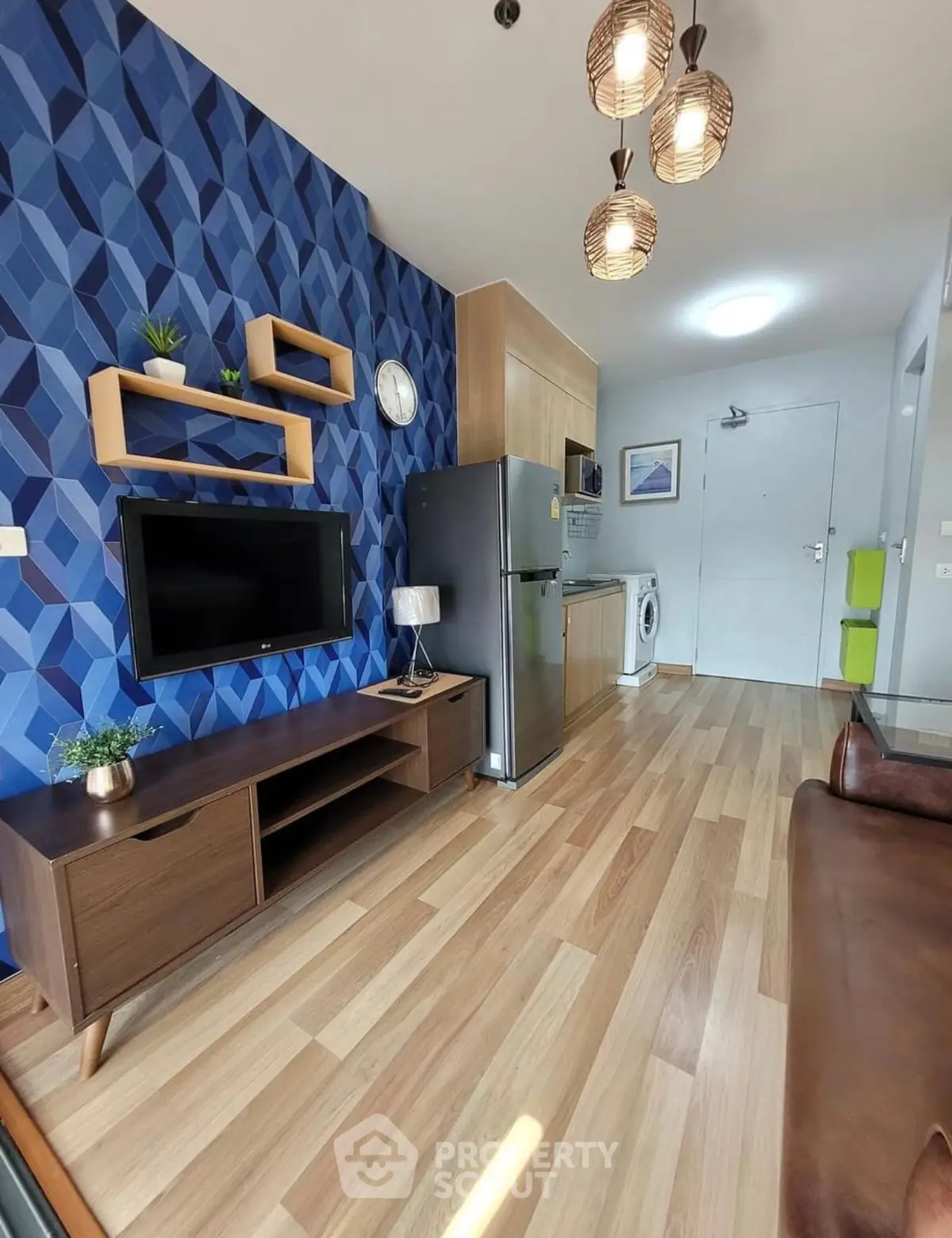 Modern living room with stylish decor, wooden flooring, and contemporary furniture in a cozy apartment.