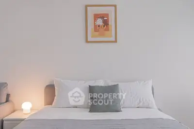 Cozy bedroom with modern decor and soft lighting, perfect for relaxation.