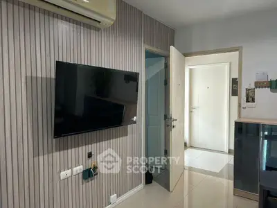 Modern living room with wall-mounted TV and air conditioning