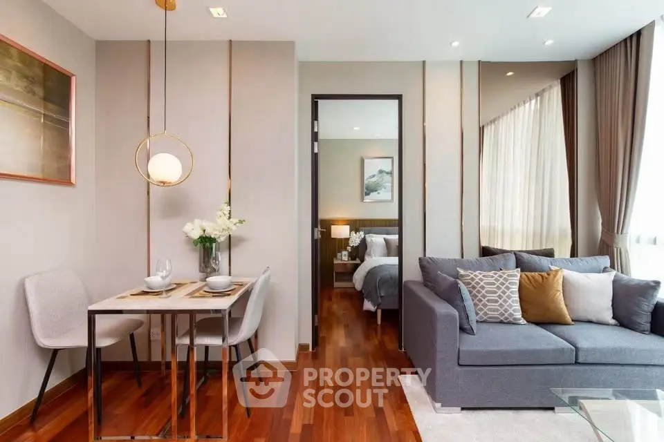Modern living room with cozy sofa and elegant dining area in open layout apartment.