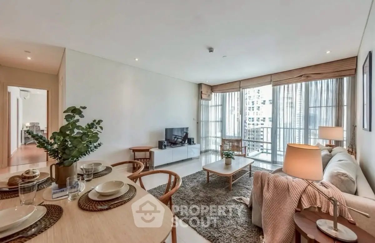 Spacious modern living room with elegant decor and city view balcony