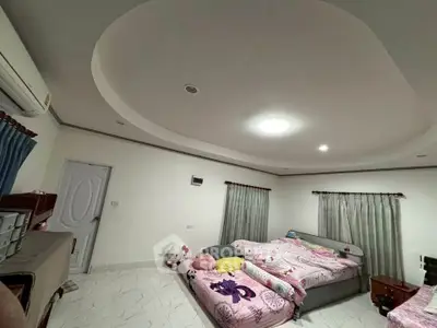 Spacious bedroom with modern ceiling design and cozy twin beds