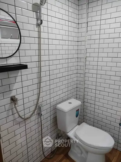 Modern bathroom with white subway tiles and sleek fixtures
