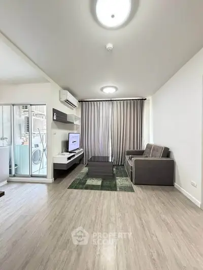 Modern living room with sleek furniture and large window for natural light