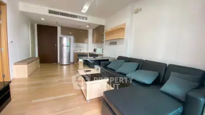 Modern living room with sleek furniture and open kitchen layout