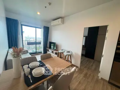 Modern living room with dining area and balcony view in stylish apartment