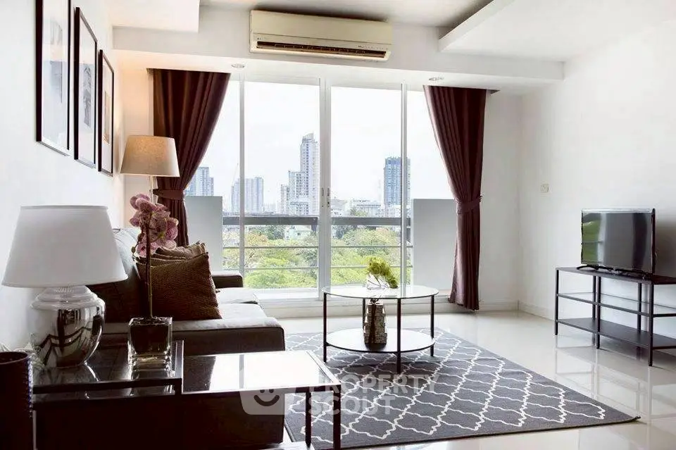 Modern living room with city view, stylish decor, and natural light.