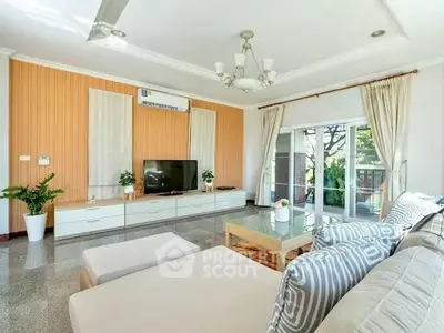 Spacious living room with modern decor and large windows for natural light.