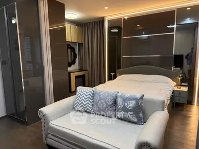 Luxurious modern bedroom with stylish decor and cozy seating area
