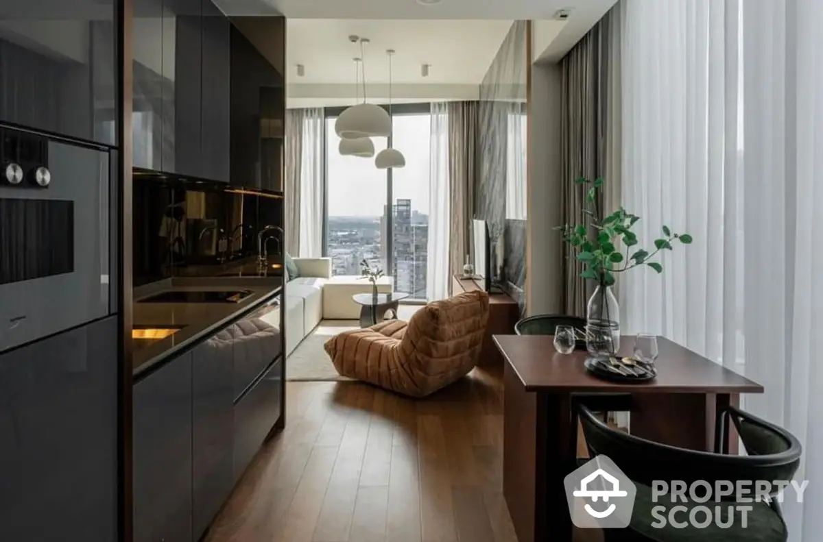 Sleek modern kitchen with high-end appliances flows into a cozy living space with floor-to-ceiling windows offering a panoramic city view, accentuated by stylish furnishings and natural light.